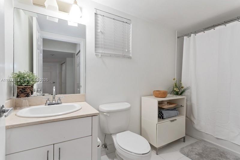 8888 Collins Avenue, Unit 115 Surfside, FL 33154 - Photo 14 of 18 a bathroom with a sink toilet and mirror