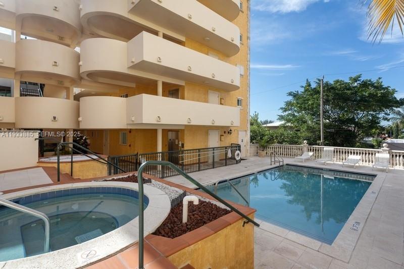 8888 Collins Avenue, Unit 115 Surfside, FL 33154 - Photo 18 of 18 a view of a swimming pool with a lounge chairs