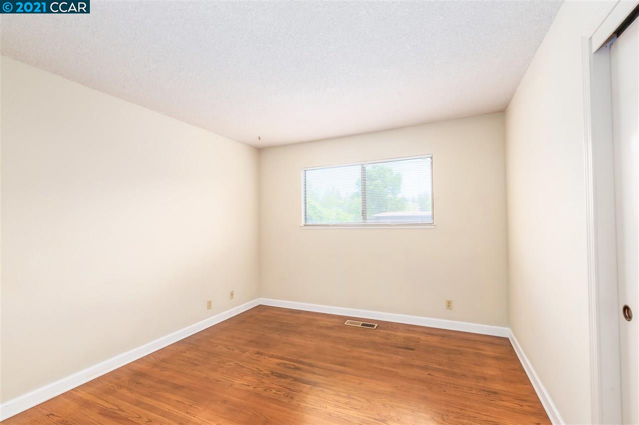 348 Barrett Circle Danville, CA 94526 - Photo 17 of 23 a view of an empty room with wooden floor and a window