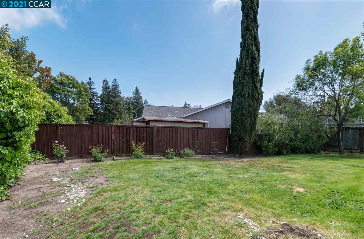 348 Barrett Circle Danville, CA 94526 - Photo 3 of 23 a view of a backyard with potted plants and wooden fence