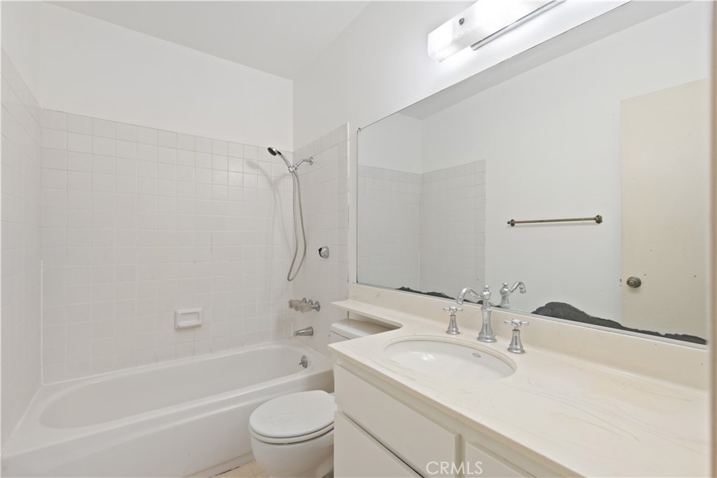 9502 Vía Salerno Burbank, CA 91504 - Photo 9 of 18 a bathroom with a bathtub shower sink vanity mirror and toilet
