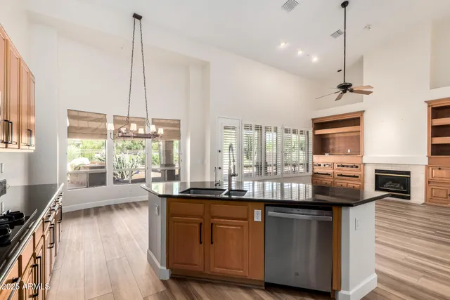 a very nice looking living room with a large window and wooden floor