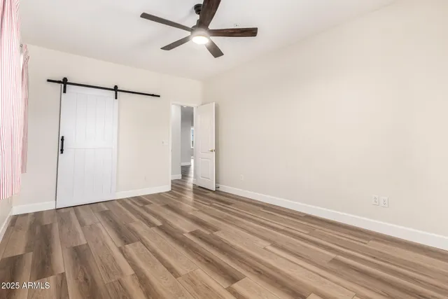 a view of empty room with wooden floor