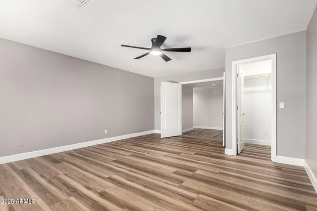 a view of empty room with wooden floor