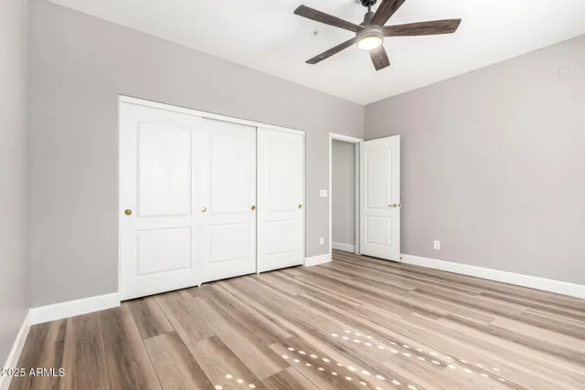a view of a room with wooden floor and white walls