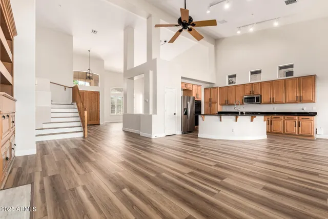 a view of a living room with wooden floor and staircase