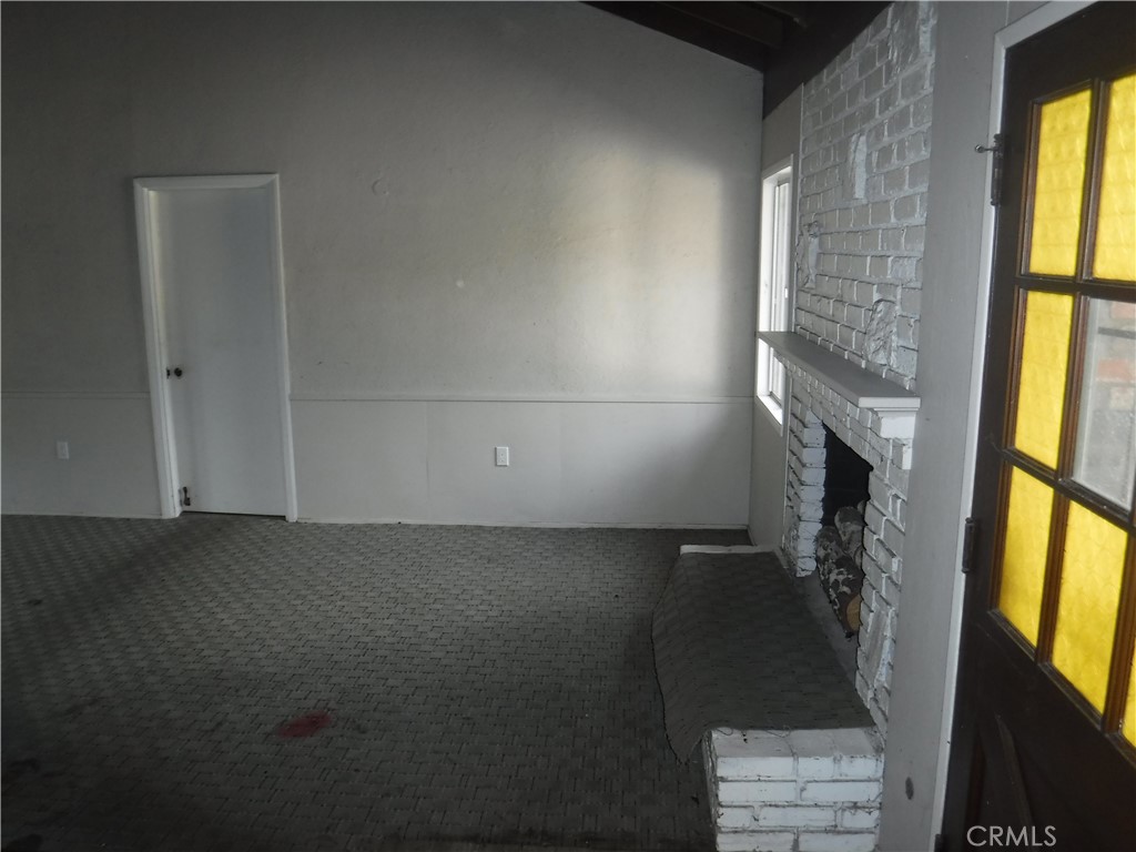 706 West Carroll Avenue Glendora, CA 91741 - Photo 17 of 24 a view of an empty room with a fireplace and a window