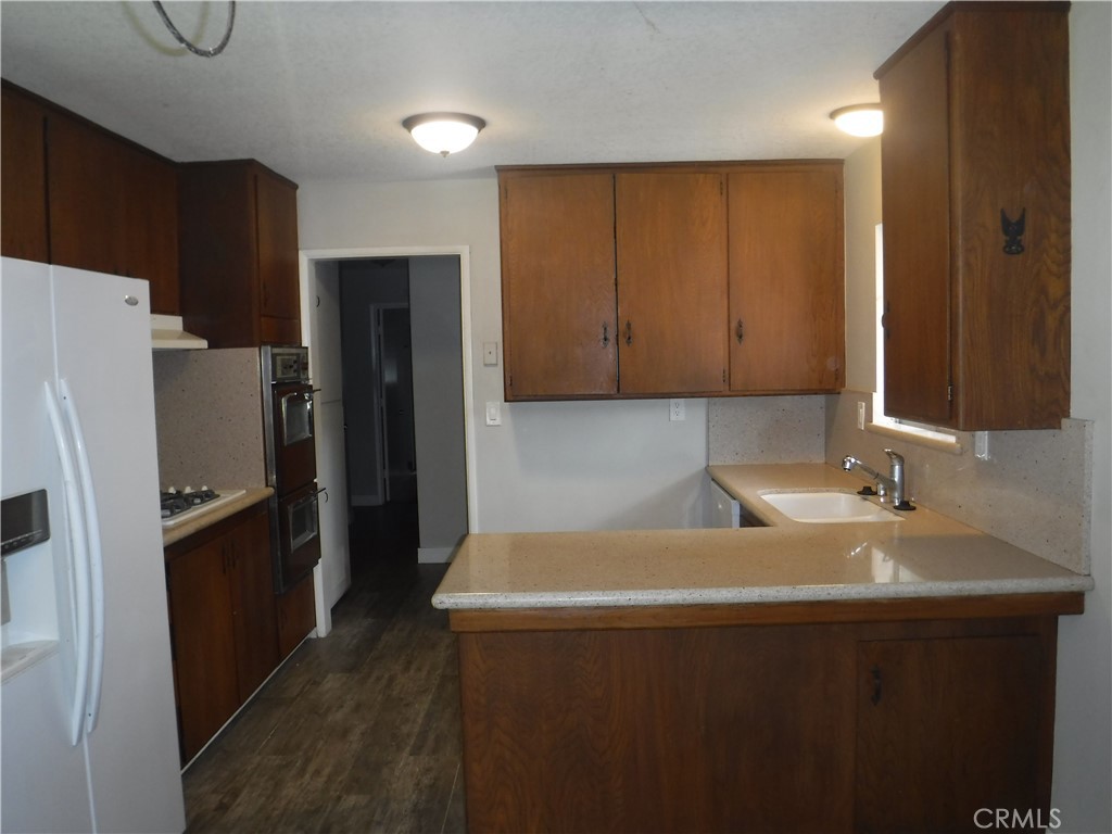 706 West Carroll Avenue Glendora, CA 91741 - Photo 7 of 24 a kitchen with stainless steel appliances a refrigerator and a sink