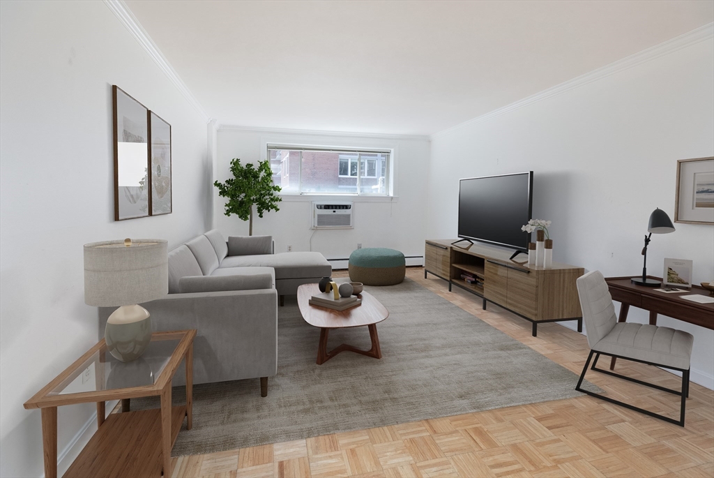 329 Harvard Street, Unit 1 Cambridge, MA 02139 - Photo 2 of 8 a living room with furniture a flat screen tv and a window