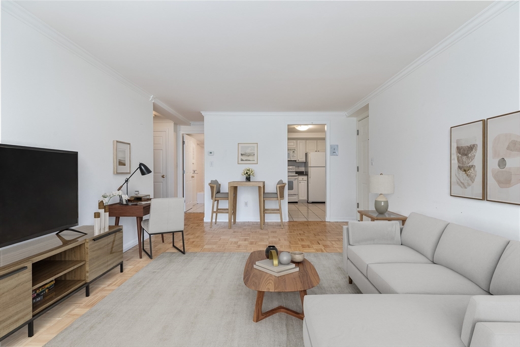 329 Harvard Street, Unit 1 Cambridge, MA 02139 - Photo 3 of 8 a living room with furniture and a flat screen tv