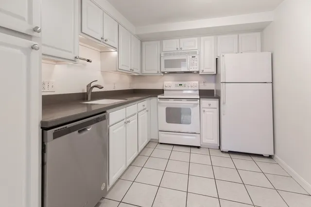 a kitchen with appliances cabinets and utility