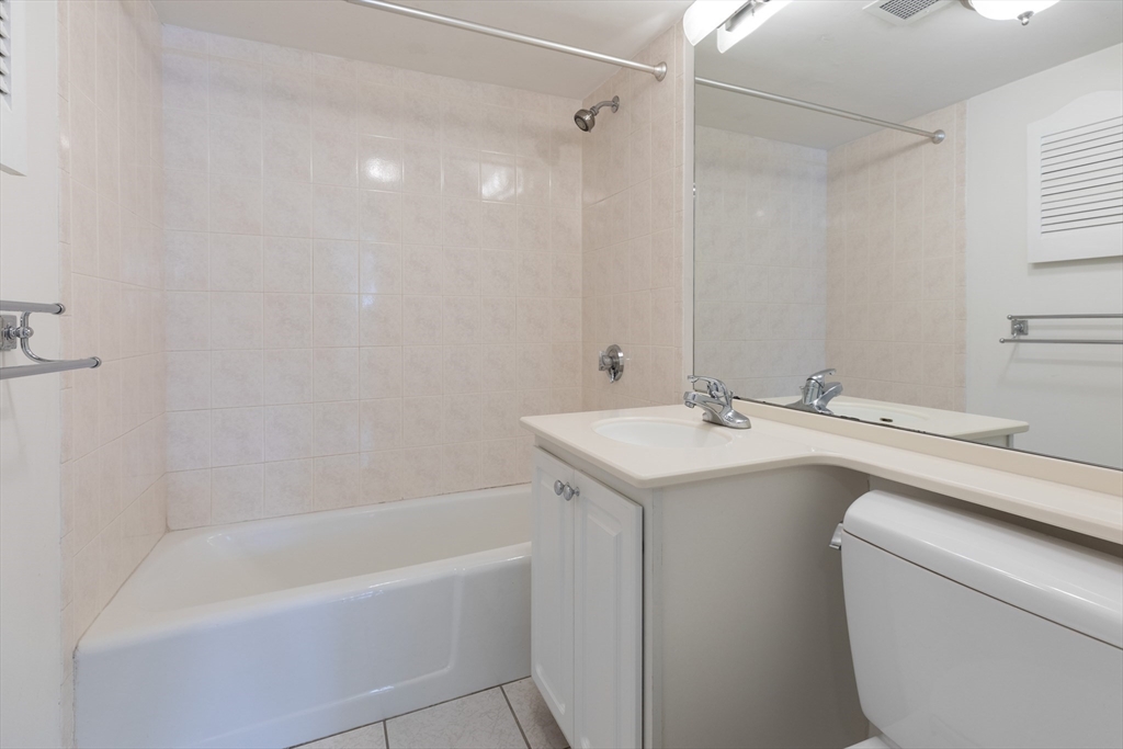 329 Harvard Street, Unit 1 Cambridge, MA 02139 - Photo 7 of 8 a bathroom with a sink a toilet and a bathtub