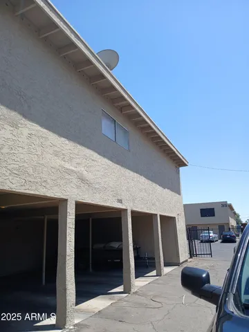 a backyard of a house with table and chairs