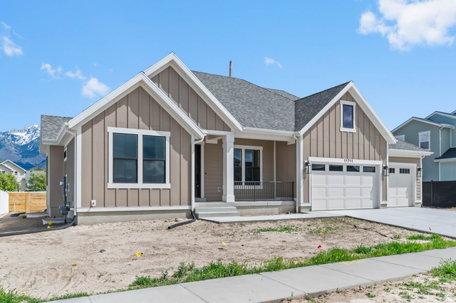 11711 South Halls Crk Road Draper, UT 84020 - Photo 3 of 31 View of front facade featuring board and batten siding, a shingled roof, covered porch, and a garage
