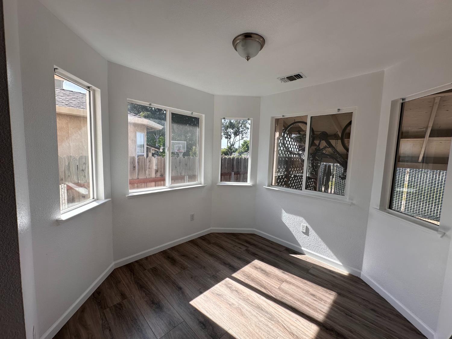 911 Toro Lane Lathrop, CA 95330 - Photo 18 of 36 Breakfast Nook featuring multiple windows, wood-finish flooring and ceiling-mount light
