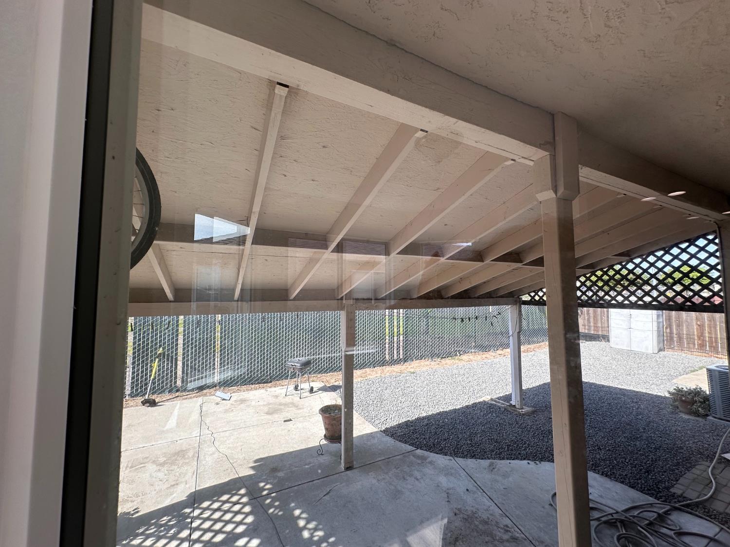 911 Toro Lane Lathrop, CA 95330 - Photo 26 of 36 Covered patio space featuring a concrete slab, gravel landscaping, and a lattice privacy screen