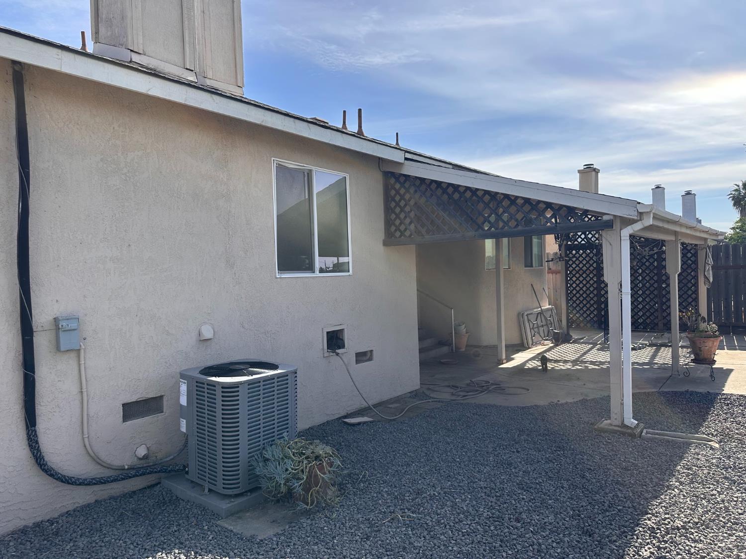 911 Toro Lane Lathrop, CA 95330 - Photo 27 of 36 Stucco exterior featuring an attached patio cover with lattice detailing