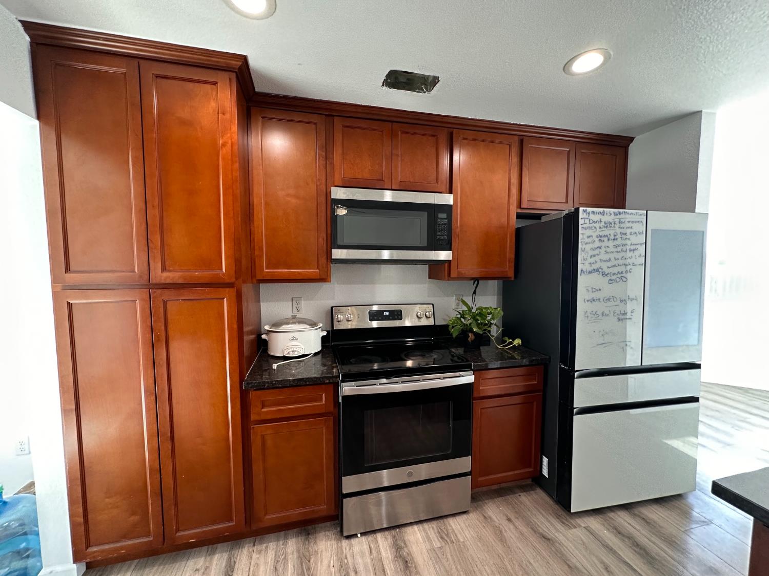 911 Toro Lane Lathrop, CA 95330 - Photo 7 of 36 Kitchen featuring extensive wood cabinetry, Granite countertops, and stainless steel appliances