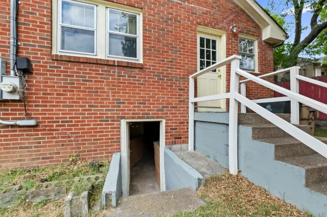 a view of front door of house with stairs