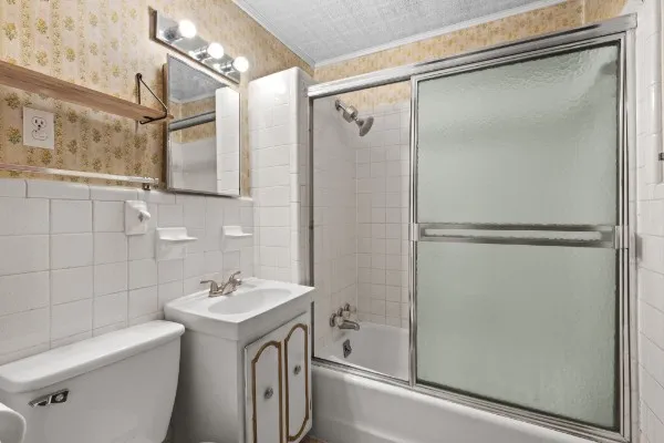 a bathroom with a shower sink and mirror