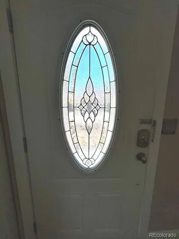 a view of a room with wooden floor and potted plant