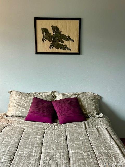 1009 Acadia Avenue Lafayette, CO 80026 - Photo 21 of 46 a bedroom with a bed and a couch