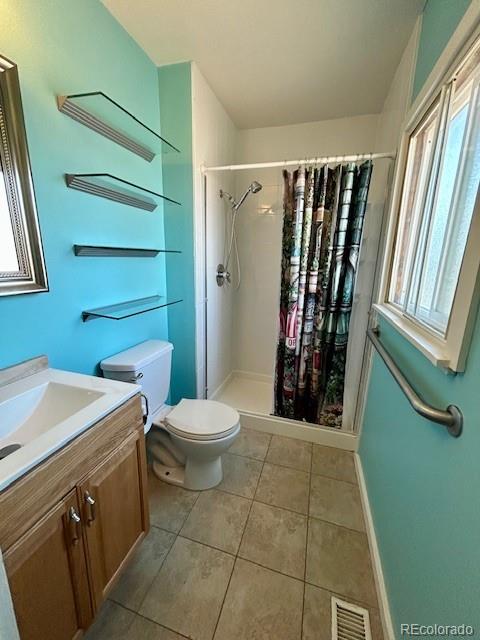 1009 Acadia Avenue Lafayette, CO 80026 - Photo 25 of 46 a bathroom with a toilet a sink and a window