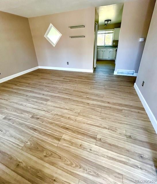 1009 Acadia Avenue Lafayette, CO 80026 - Photo 3 of 46 a view of a room with wooden floor and potted plant