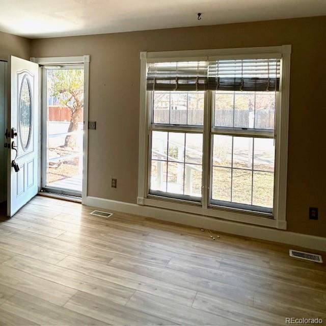 1009 Acadia Avenue Lafayette, CO 80026 - Photo 6 of 46 a view of an empty room with wooden floor and a window