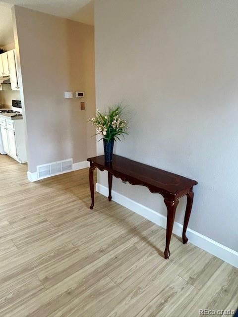 1009 Acadia Avenue Lafayette, CO 80026 - Photo 7 of 46 a view of a room with wooden floor and a potted plant