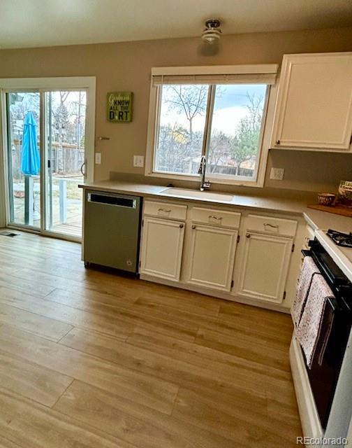 1009 Acadia Avenue Lafayette, CO 80026 - Photo 9 of 46 a kitchen with stainless steel appliances granite countertop a stove a sink and a microwave