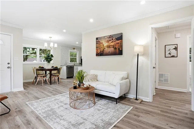 a view of a dining room with furniture a livingroom and chandelier