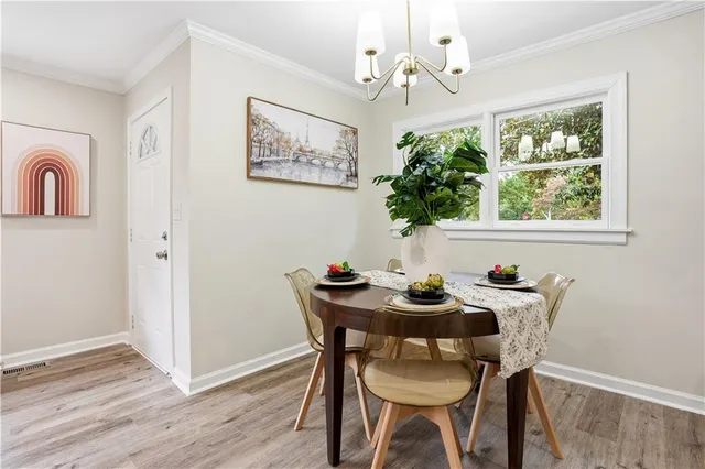 a table room with furniture and a potted plant