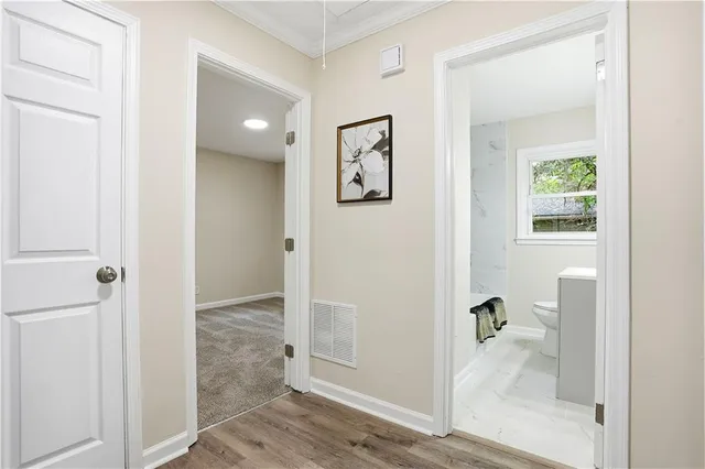 a bathroom with a sink a toilet and a window