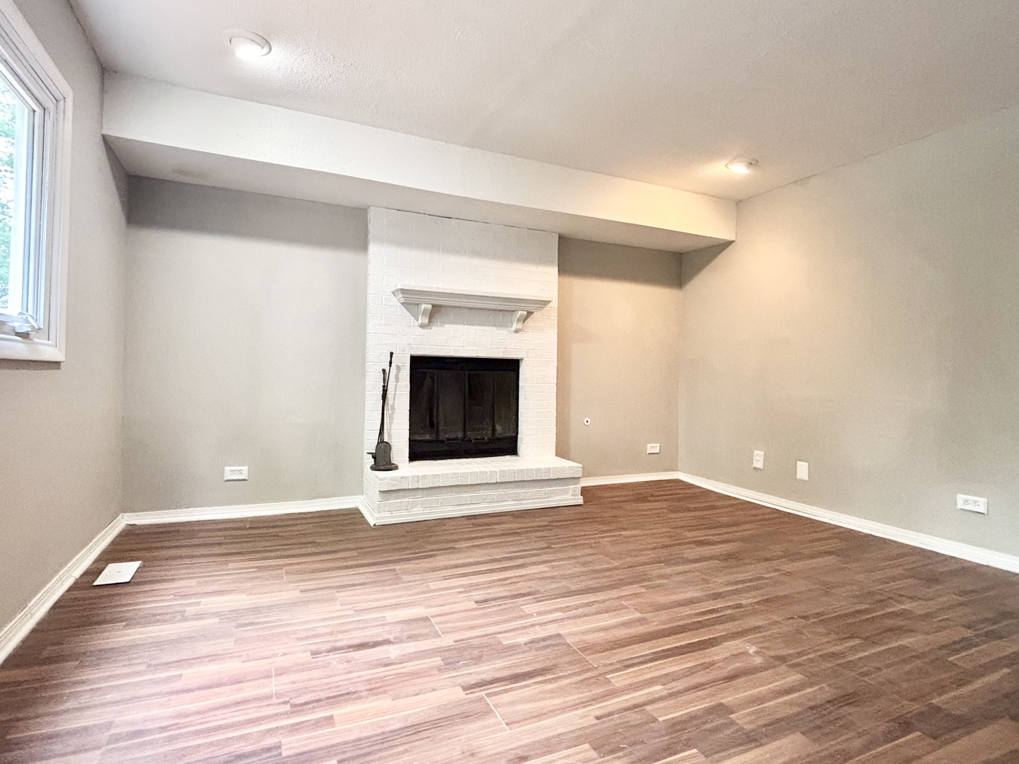 615 North Blanchard Street Wheaton, IL 60187 - Photo 14 of 19 an empty room with wooden floor and fireplace