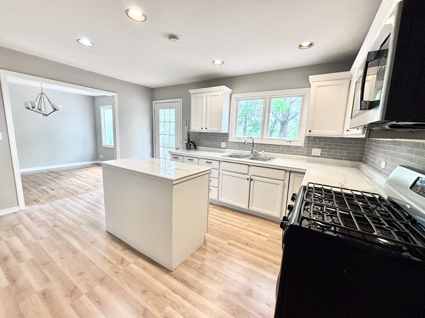 615 North Blanchard Street Wheaton, IL 60187 - Photo 4 of 19 a kitchen with a sink stove and cabinets