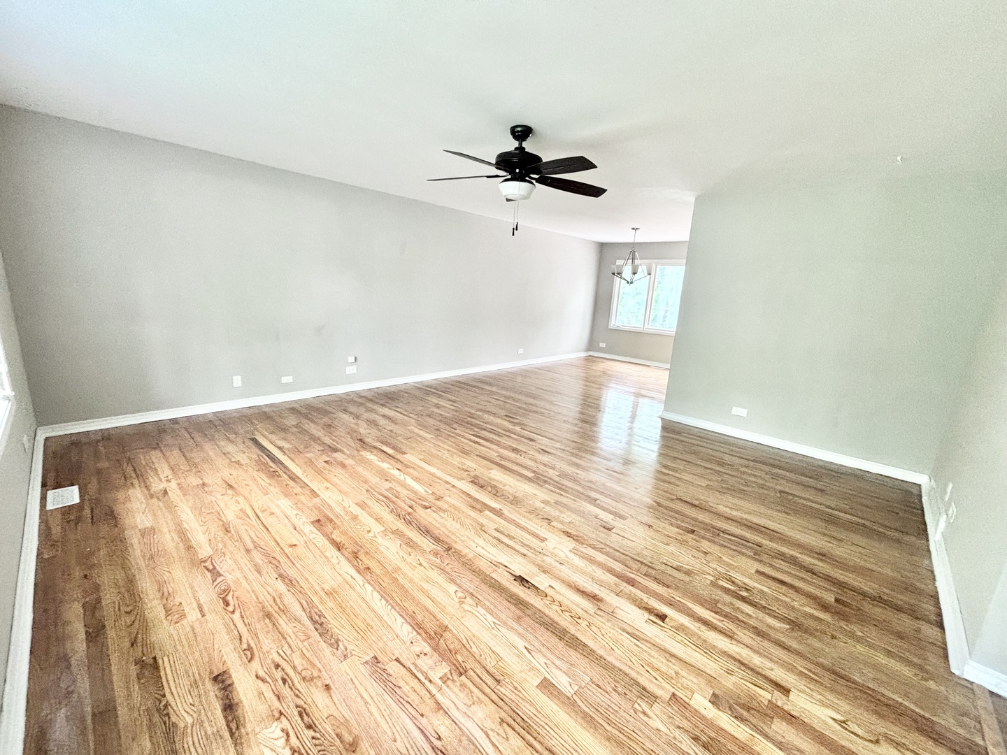 615 North Blanchard Street Wheaton, IL 60187 - Photo 6 of 19 an empty room with wooden floor ceiling fan and windows