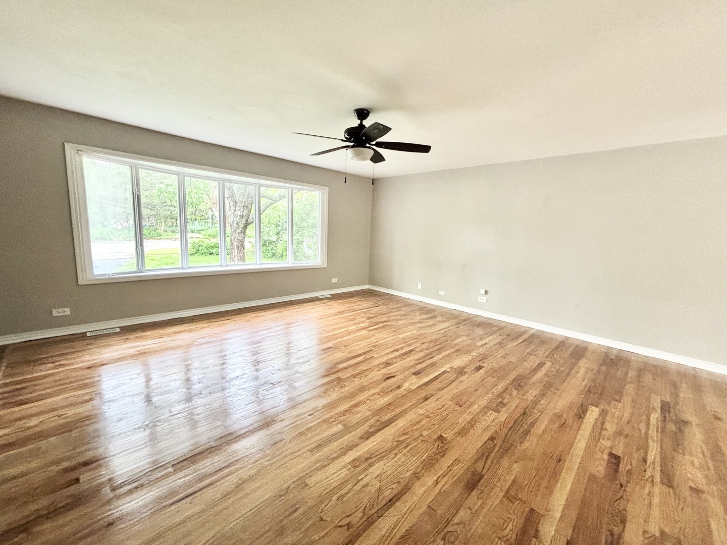 615 North Blanchard Street Wheaton, IL 60187 - Photo 7 of 19 an empty room with wooden floor ceiling fan and windows