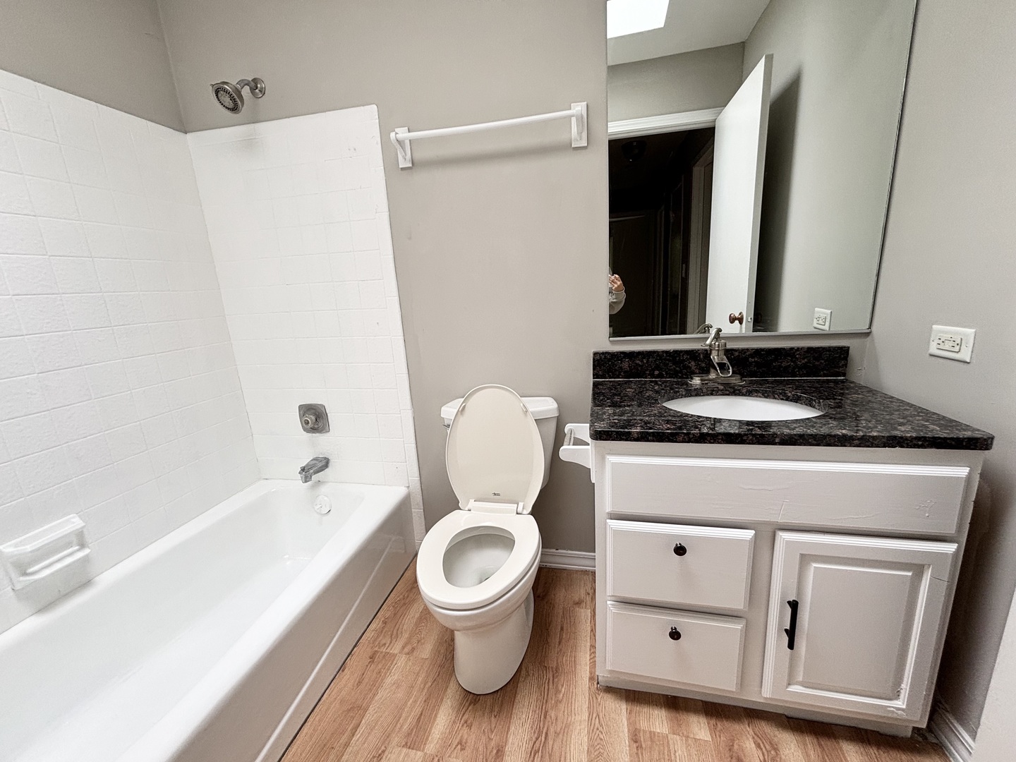 615 North Blanchard Street Wheaton, IL 60187 - Photo 8 of 19 a bathroom with a granite countertop toilet sink and mirror