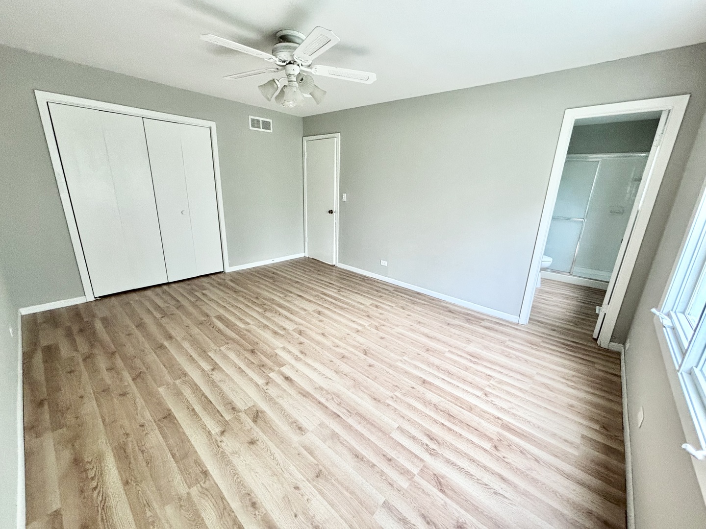 615 North Blanchard Street Wheaton, IL 60187 - Photo 9 of 19 an empty room with wooden floor and fan