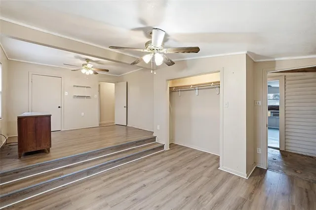a view of an empty room and wooden floor