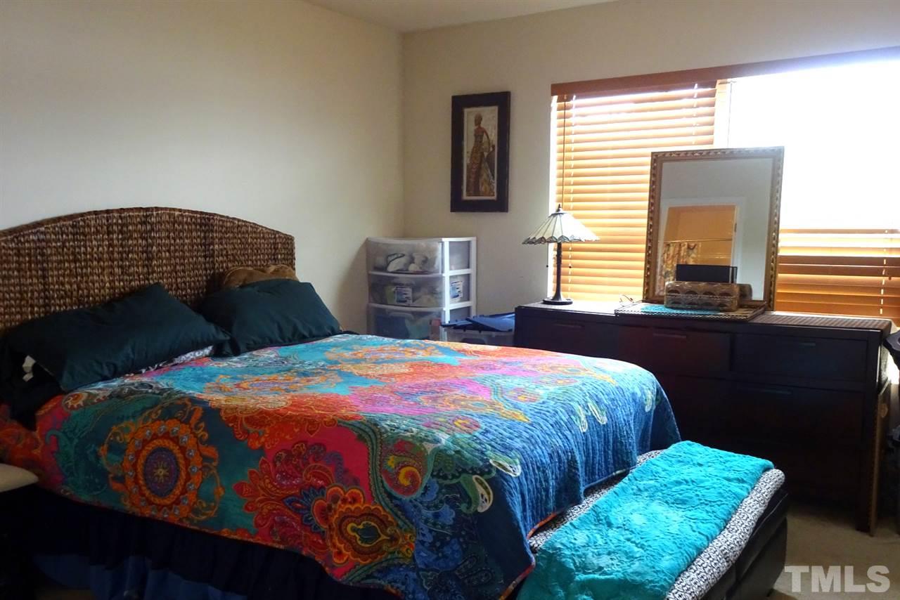 2938 Berkeley Springs Place Raleigh, NC 27616 - Photo 13 of 19 a bedroom with a bed a dresser next to a window