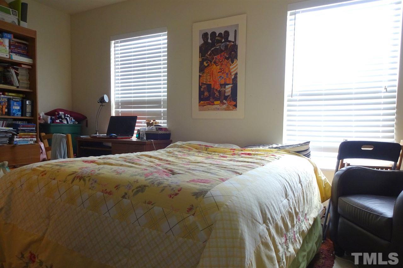 2938 Berkeley Springs Place Raleigh, NC 27616 - Photo 15 of 19 a bedroom with a bed and a window