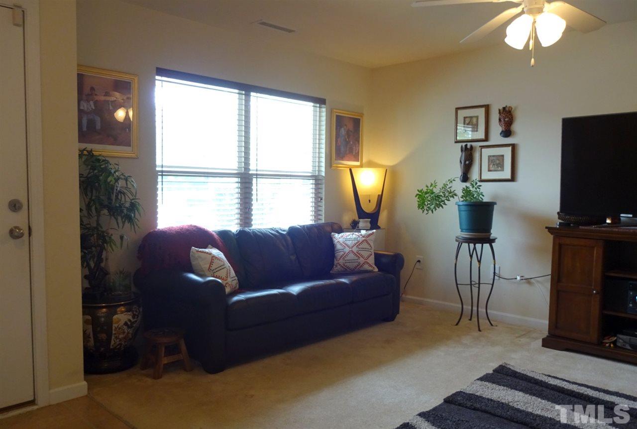 2938 Berkeley Springs Place Raleigh, NC 27616 - Photo 5 of 19 a living room with furniture a flat screen tv and a window
