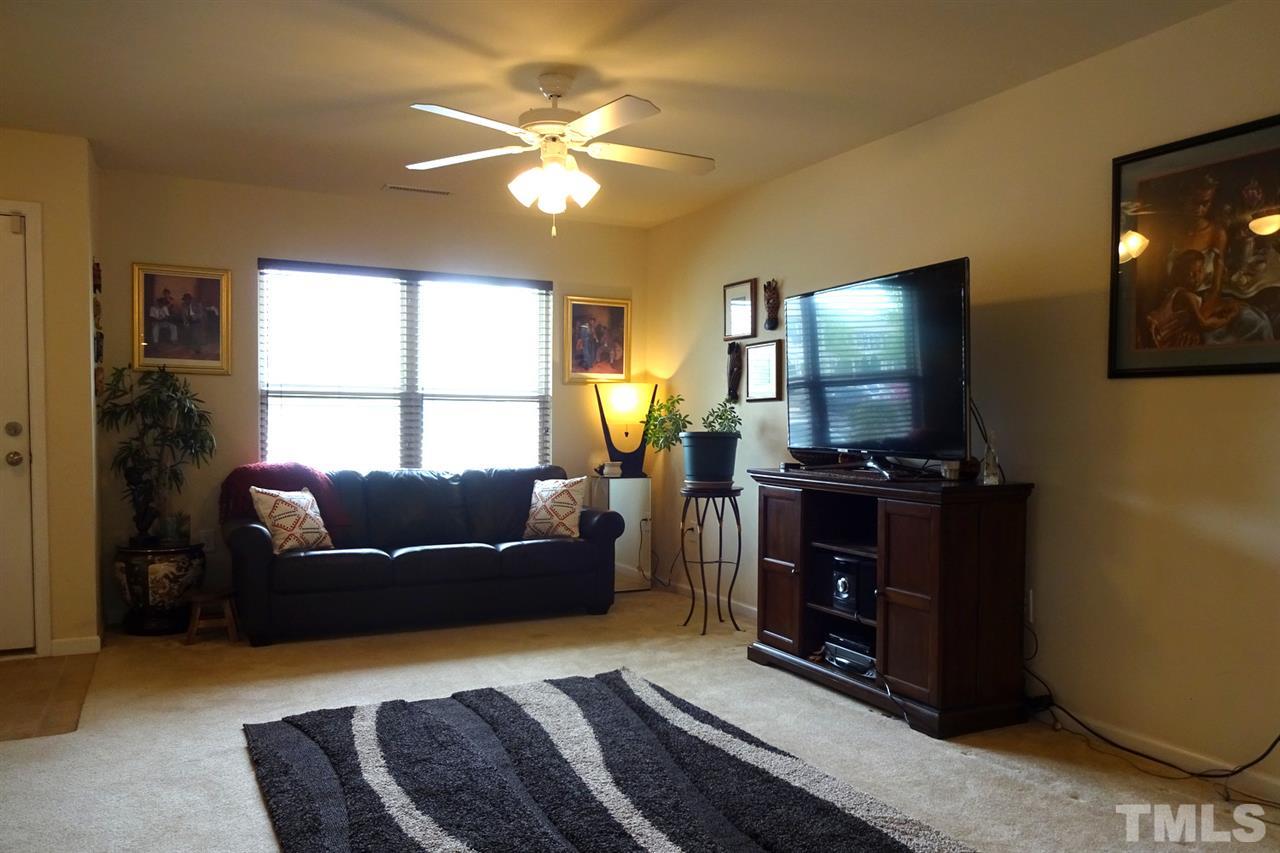 2938 Berkeley Springs Place Raleigh, NC 27616 - Photo 6 of 19 a living room with furniture and a flat screen tv
