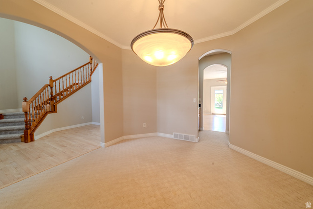 598 Hollow Creek Road Draper, UT 84020 - Photo 23 of 110 Recessed dining space featuring crown molding and a semi-flush mount chandelier