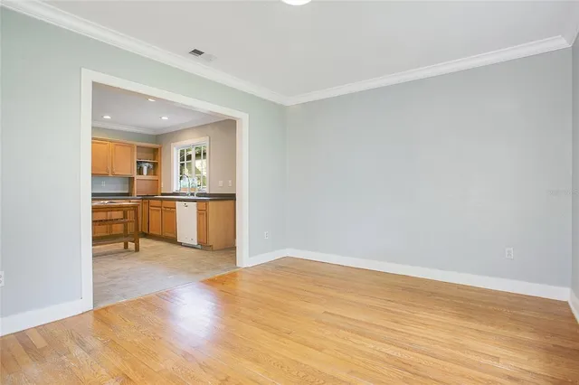 a view of a kitchen with wooden floor and a sink
