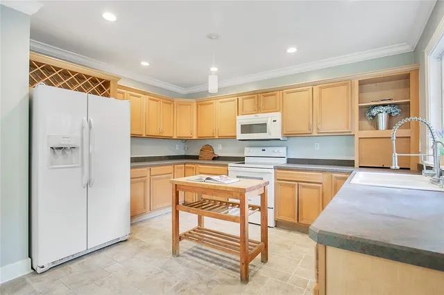 a kitchen with stainless steel appliances granite countertop a refrigerator sink and cabinets