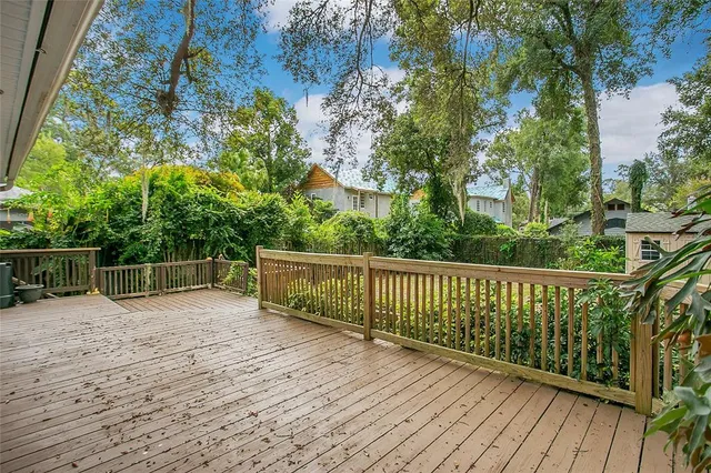 a view of balcony with wooden floor and fence