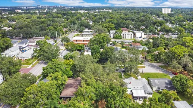 an aerial view of residential house with outdoor space and trees